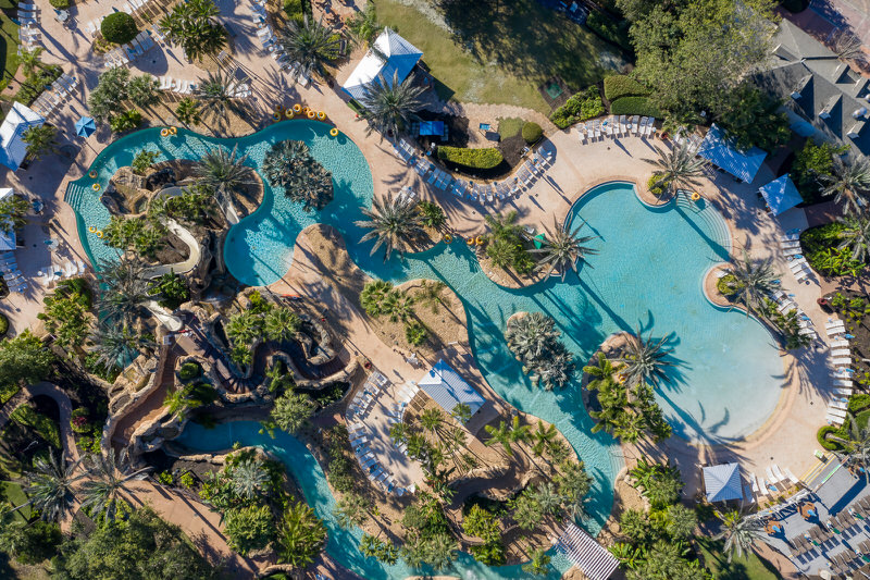 Aerial view of the entire five-acre Reunion Resort Water Park, showcasing the lazy river, slides, and pools under sunny Florida skies