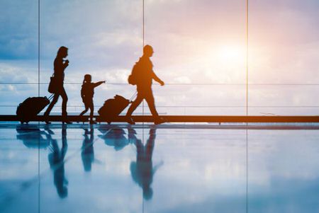 family walking through the airport